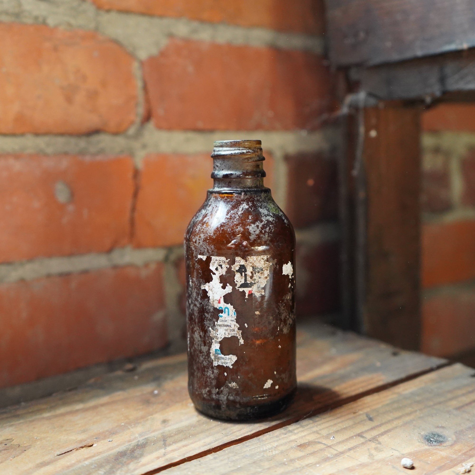 Vintage Small Brown Glass Bottle with Worn Label – Dug Up